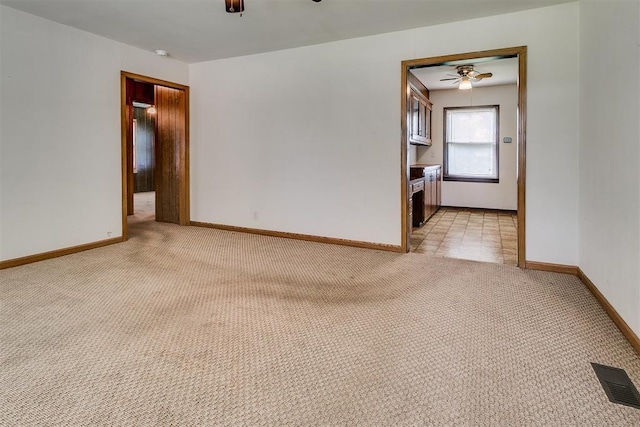 1817 W Harrison Ave, Guthrie, OK 73044 - unfurnished room with light colored carpet, a ceiling fan, and a smoke detector