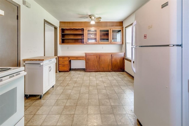 1817 W Harrison Ave, Guthrie, OK 73044 - kitchen featuring white appliances, light countertops, ceiling fan, open shelves, and brown cabinetry