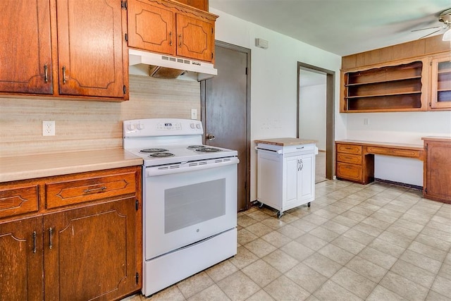 1817 W Harrison Ave, Guthrie, OK 73044 - kitchen with electric stove, under cabinet range hood, a ceiling fan, light countertops, and open shelves