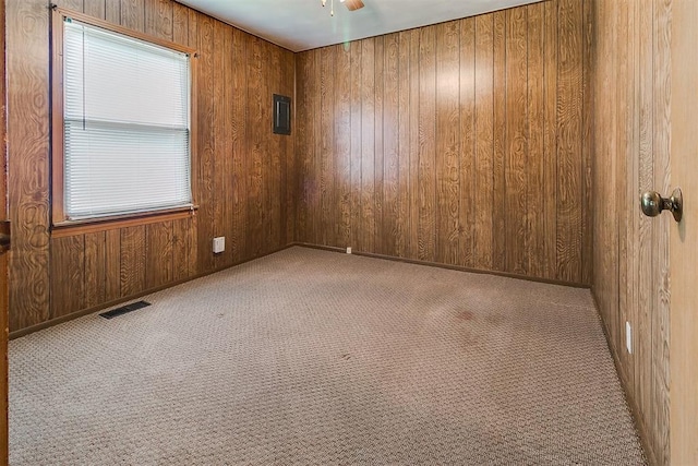 1817 W Harrison Ave, Guthrie, OK 73044 - empty room featuring wooden walls, carpet flooring, and a ceiling fan