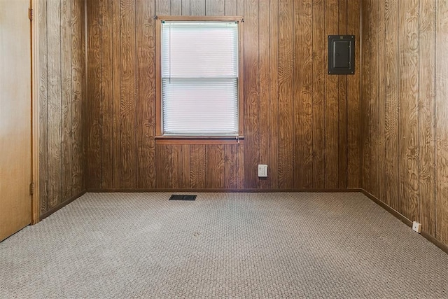 1817 W Harrison Ave, Guthrie, OK 73044 - carpeted empty room with electric panel and wood walls