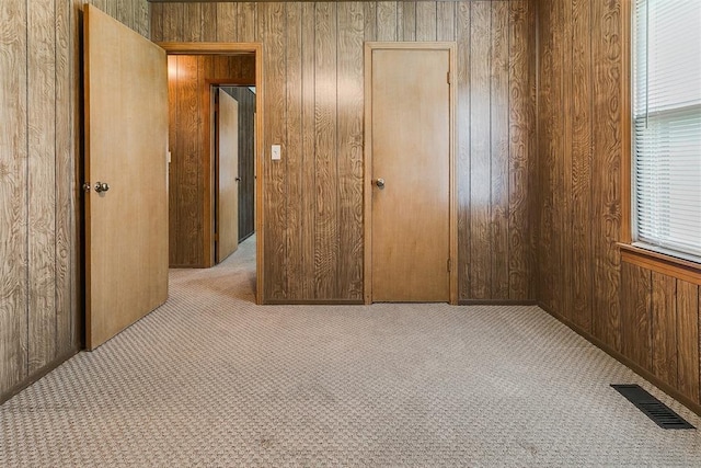1817 W Harrison Ave, Guthrie, OK 73044 - unfurnished bedroom featuring carpet floors and wood walls