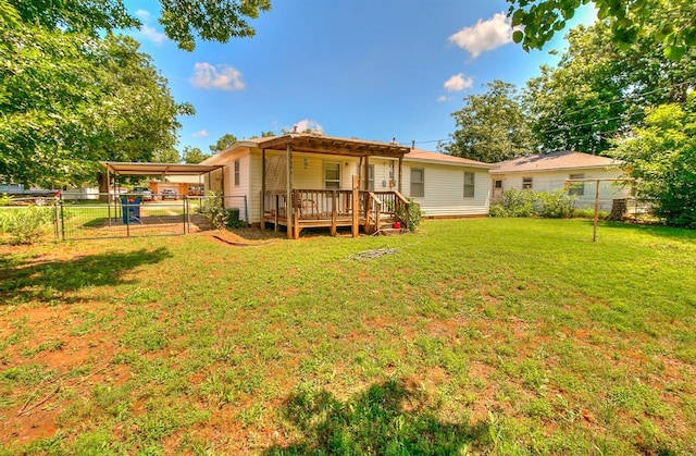 1817 W Harrison Ave, Guthrie, OK 73044 - back of house featuring a fenced backyard, a gate, a wooden deck, and a carport