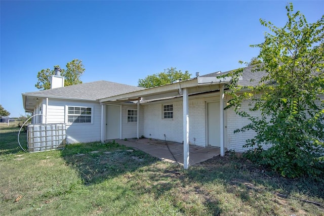 45350 Bob Crouch Rd, Tecumseh, OK 74873 - back of property featuring a chimney, a patio area, a yard, and a shingled roof