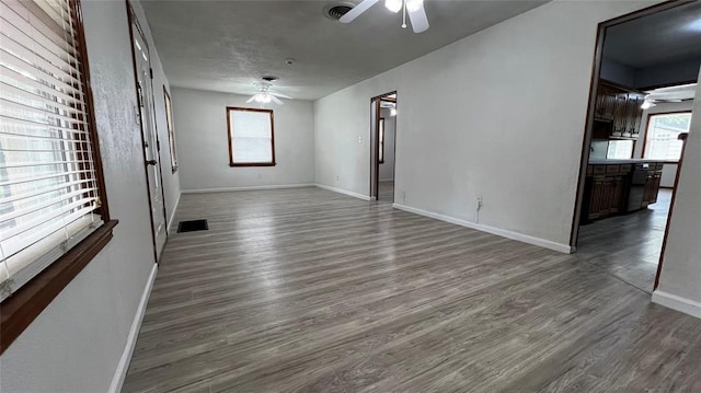 425 Mohawk Dr, Pauls Valley, OK 73075 - unfurnished living room with a ceiling fan, plenty of natural light, and dark wood finished floors