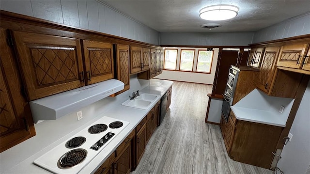 425 Mohawk Dr, Pauls Valley, OK 73075 - kitchen with light wood-type flooring, white electric cooktop, brown cabinets, exhaust hood, and black dishwasher