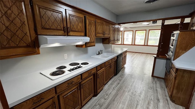 425 Mohawk Dr, Pauls Valley, OK 73075 - kitchen with under cabinet range hood, white electric cooktop, light wood-style flooring, black dishwasher, and light countertops