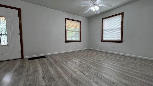 425 Mohawk Dr, Pauls Valley, OK 73075 - entrance foyer featuring wood finished floors, a ceiling fan, and a textured ceiling