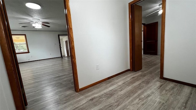 425 Mohawk Dr, Pauls Valley, OK 73075 - corridor featuring wood finished floors and a textured ceiling