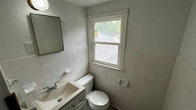 425 Mohawk Dr, Pauls Valley, OK 73075 - half bathroom featuring tile walls, vanity, and a wainscoted wall