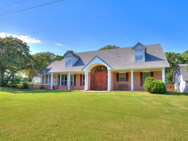 1124 Hill View Dr, Guthrie, OK 73044 - cape cod home featuring brick siding, covered porch, and a shingled roof