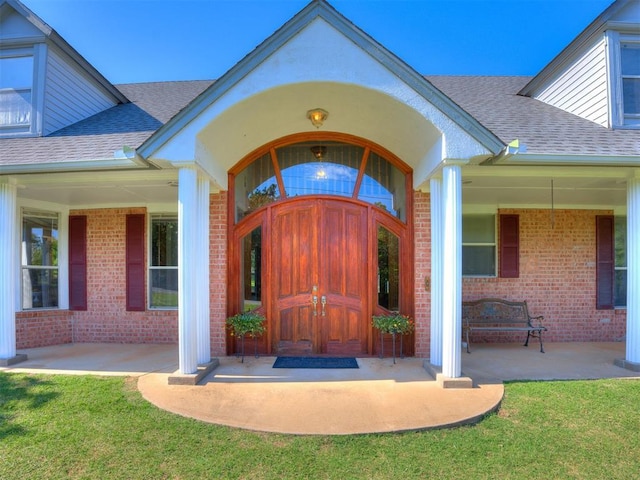 1124 Hill View Dr, Guthrie, OK 73044 - property entrance featuring roof with shingles, brick siding, and a lawn