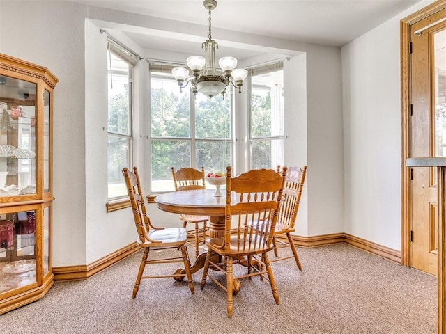 1124 Hill View Dr, Guthrie, OK 73044 - carpeted dining area with a chandelier and baseboards