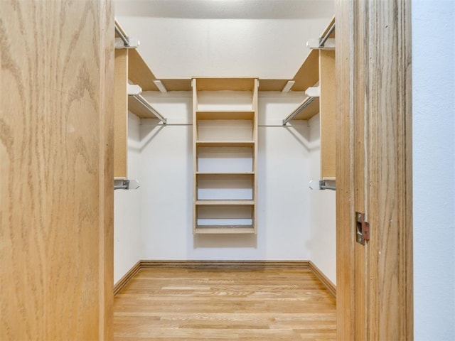1124 Hill View Dr, Guthrie, OK 73044 - walk in closet with wood finished floors