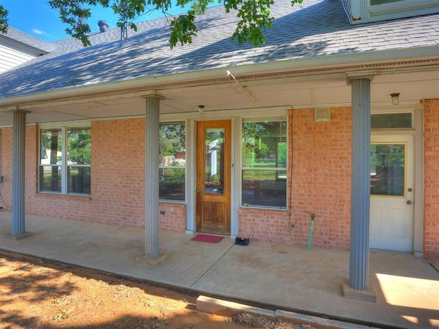 1124 Hill View Dr, Guthrie, OK 73044 - entrance to property with roof with shingles, brick siding, and a patio