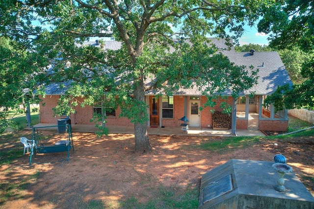 1124 Hill View Dr, Guthrie, OK 73044 - back of house featuring brick siding, a patio, and roof with shingles