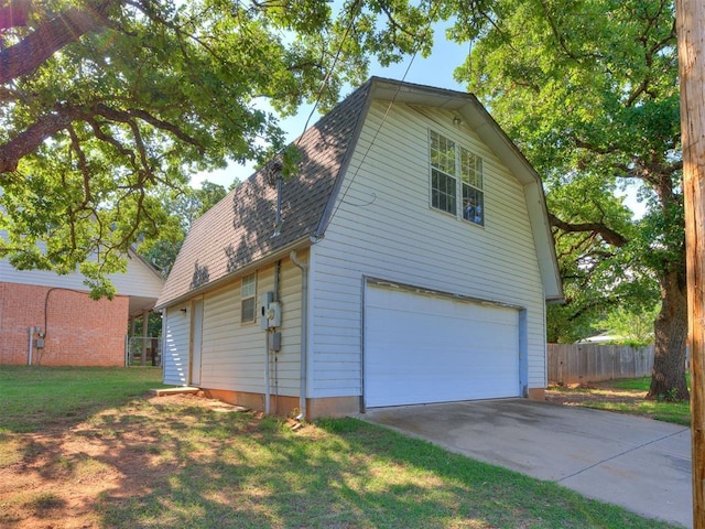 1124 Hill View Dr, Guthrie, OK 73044 - view of home's exterior featuring a gambrel roof, roof with shingles, an attached garage, and driveway
