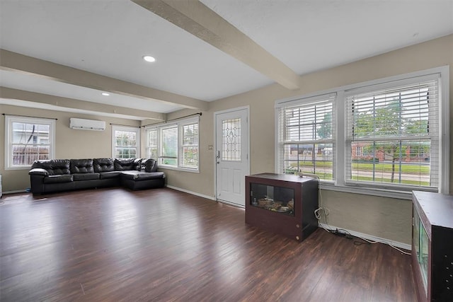 231 W Polk St, Mangum, OK 73554 - living area featuring a wall unit AC, beamed ceiling, dark wood-type flooring, and recessed lighting