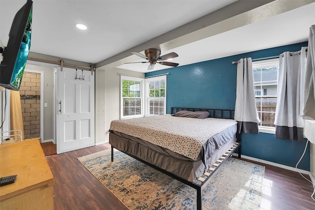 231 W Polk St, Mangum, OK 73554 - bedroom featuring a barn door, wood finished floors, multiple windows, and recessed lighting