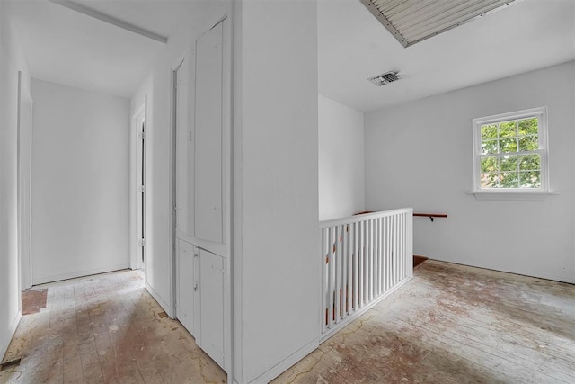 231 W Polk St, Mangum, OK 73554 - corridor with hardwood / wood-style floors and an upstairs landing