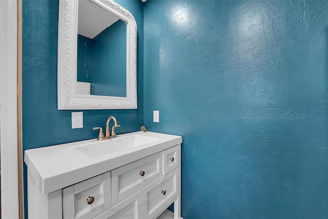 231 W Polk St, Mangum, OK 73554 - bathroom with vanity and a textured wall