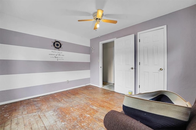231 W Polk St, Mangum, OK 73554 - interior space with a ceiling fan and wood-type flooring