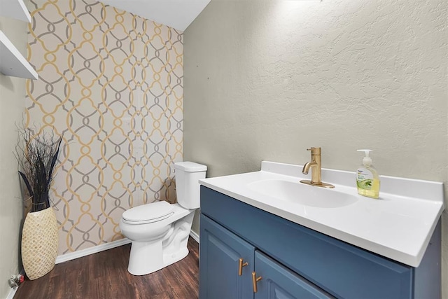 231 W Polk St, Mangum, OK 73554 - bathroom with vanity, wood finished floors, and vaulted ceiling