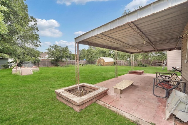 231 W Polk St, Mangum, OK 73554 - fenced backyard with a patio area and a storage unit