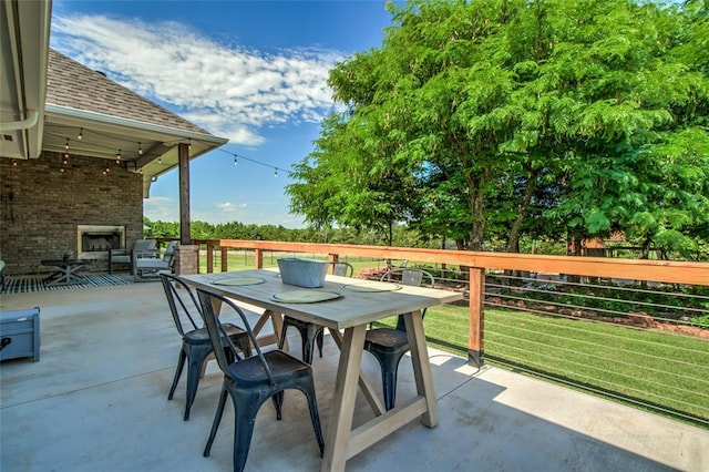 13420 Saltgrass Dr, Edmond, OK 73025 - view of patio / terrace featuring an outdoor brick fireplace, outdoor dining area, and area for grilling