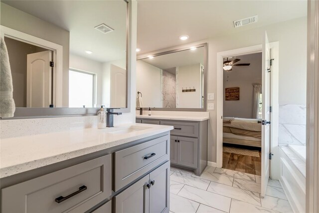 13420 Saltgrass Dr, Edmond, OK 73025 - bathroom with vanity, marble look tile flooring, ensuite bath, a bath, and recessed lighting