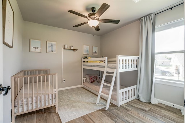 13420 Saltgrass Dr, Edmond, OK 73025 - bedroom featuring wood finished floors, a nursery area, and ceiling fan