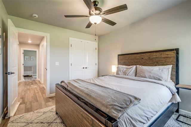 13420 Saltgrass Dr, Edmond, OK 73025 - bedroom with radiator, light wood-style flooring, a closet, and ceiling fan