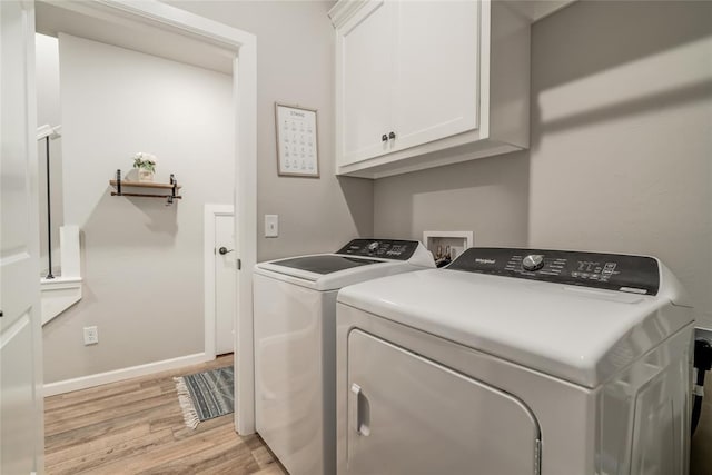 13420 Saltgrass Dr, Edmond, OK 73025 - laundry area featuring washer and dryer, cabinet space, and light wood-style flooring