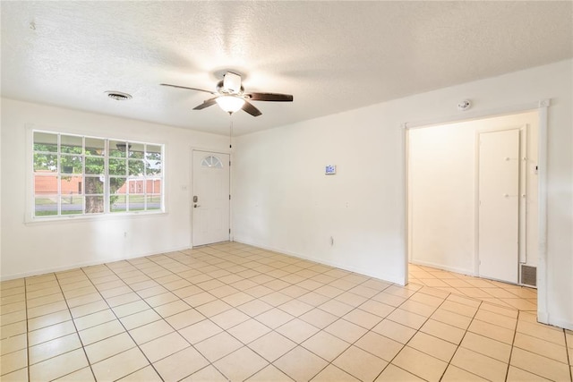 304 S 4th St, Noble, OK 73068 - empty room featuring ceiling fan, a textured ceiling, a smoke detector, and light tile patterned floors