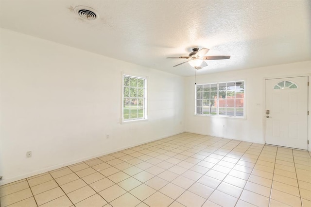 304 S 4th St, Noble, OK 73068 - unfurnished room featuring a ceiling fan, a textured ceiling, and light tile patterned floors