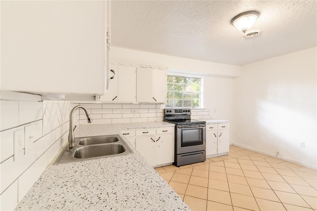 304 S 4th St, Noble, OK 73068 - kitchen featuring stainless steel electric range, light countertops, white cabinets, backsplash, and a textured ceiling