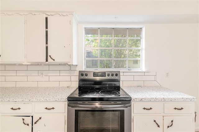 304 S 4th St, Noble, OK 73068 - kitchen featuring stainless steel electric range oven, decorative backsplash, white cabinetry, and light stone counters