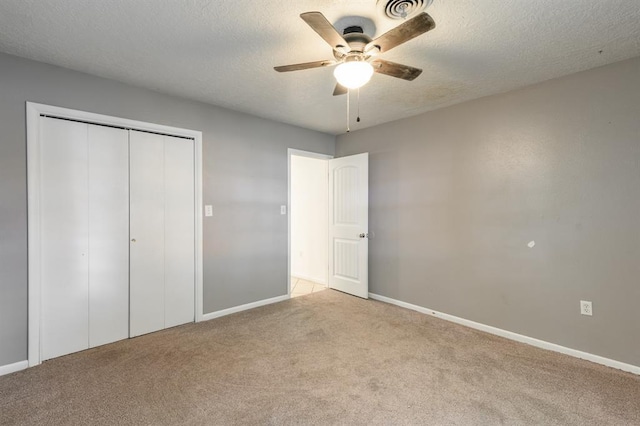 304 S 4th St, Noble, OK 73068 - unfurnished bedroom with carpet flooring, a closet, a textured ceiling, and a ceiling fan