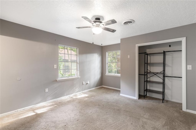 304 S 4th St, Noble, OK 73068 - unfurnished bedroom with carpet floors, a textured ceiling, and a ceiling fan
