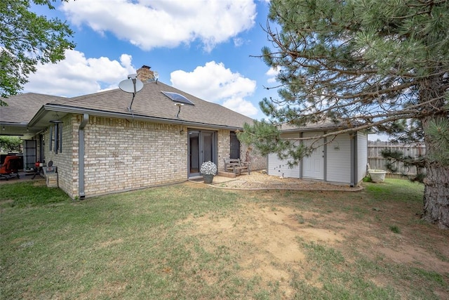 2205 SE 90th St, Lawton, OK 73501 - rear view of property with a chimney, a shingled roof, and brick siding