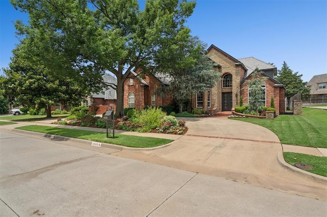 4609 Flint Ridge Dr, Norman, OK 73072 - view of front of property featuring brick siding and a front lawn