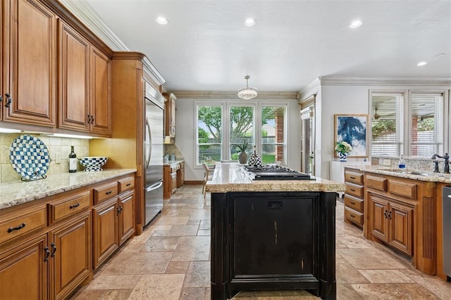 4609 Flint Ridge Dr, Norman, OK 73072 - kitchen with appliances with stainless steel finishes, brown cabinets, a kitchen island, stone tile floors, and ornamental molding