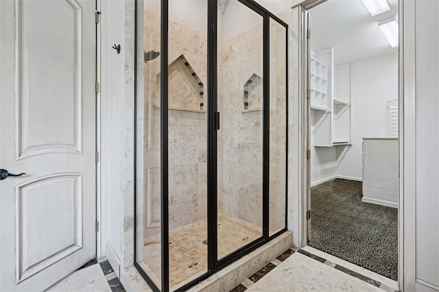 4609 Flint Ridge Dr, Norman, OK 73072 - bathroom featuring a shower stall, inlaid floor details, and a walk in closet