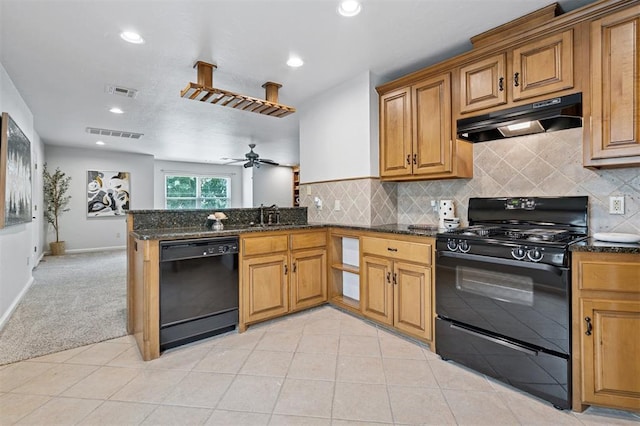 4609 Flint Ridge Dr, Norman, OK 73072 - kitchen with black appliances, under cabinet range hood, dark stone countertops, a peninsula, and recessed lighting