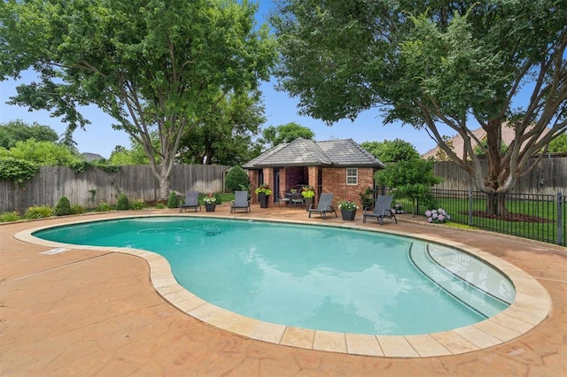 4609 Flint Ridge Dr, Norman, OK 73072 - view of pool with a fenced backyard, a patio area, and an outbuilding