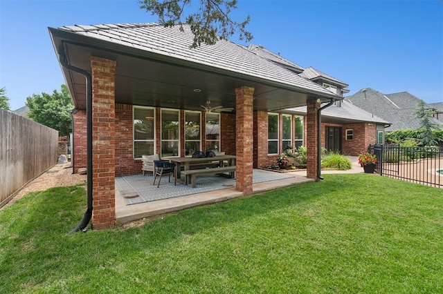 4609 Flint Ridge Dr, Norman, OK 73072 - back of house featuring a fenced backyard, brick siding, and a patio