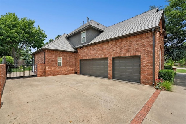 4609 Flint Ridge Dr, Norman, OK 73072 - view of home's exterior featuring brick siding, concrete driveway, and an attached garage