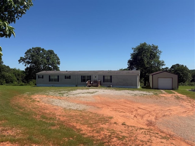 339133 E 870th Rd, Chandler, OK 74834 - manufactured / mobile home featuring dirt driveway, an outbuilding, a detached garage, and a front lawn