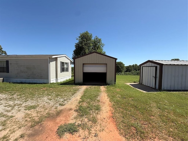 339133 E 870th Rd, Chandler, OK 74834 - view of grassy yard featuring an outbuilding, dirt driveway, and a garage