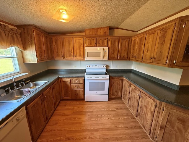 339133 E 870th Rd, Chandler, OK 74834 - kitchen featuring white appliances, lofted ceiling, light wood finished floors, a textured ceiling, and brown cabinets